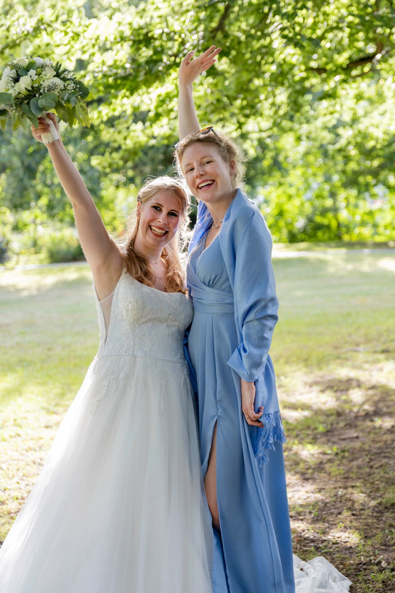 two women in dresses posing for a picture